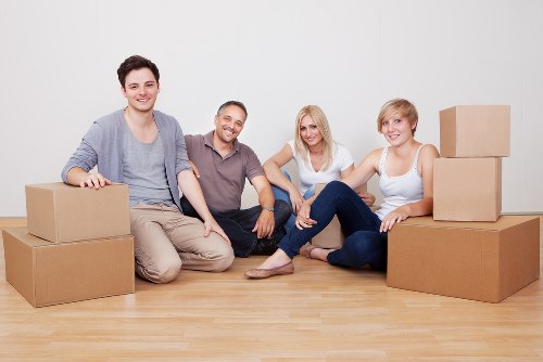 Professional movers carrying furniture in Anerley